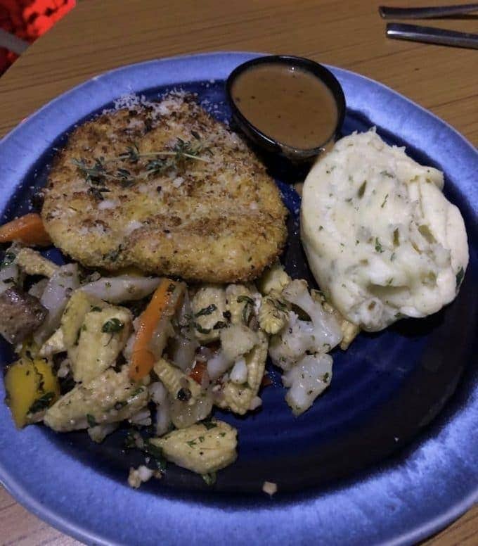 chicken with a side of mashed potato and roasted vegetables