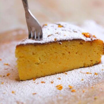 Image of fork in a slice of orange cake showing texture.
