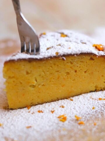 Image of fork in a slice of orange cake showing texture.