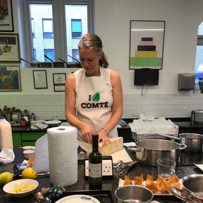 Laura Pope cutting Comté