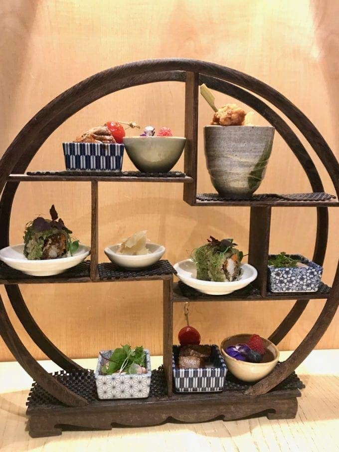Circular stand with small Japanese dishes.