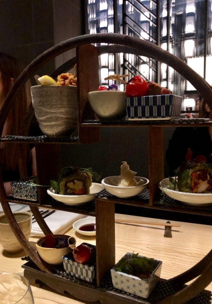 Tea stand containing small Japanese dishes.