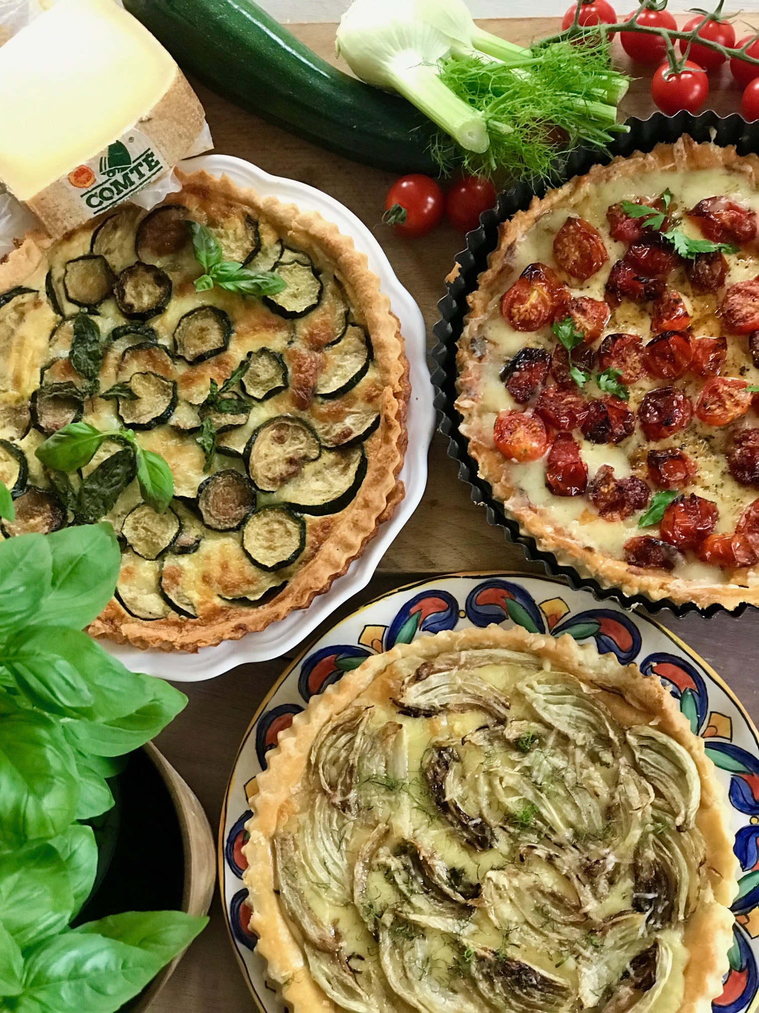 ariel view of the 3 tarts with a wedge of young Comté cheese