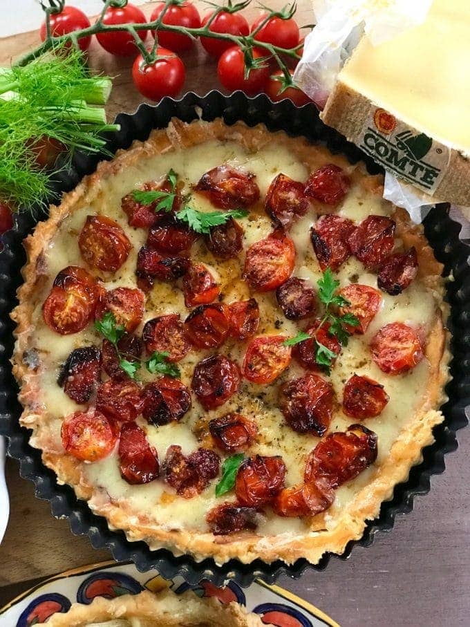 tomato tart next to a piece Comté cheese