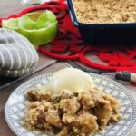 Plate with apple crumble and scoop of ice cream