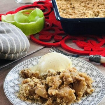 Plate with apple crumble and scoop of ice cream