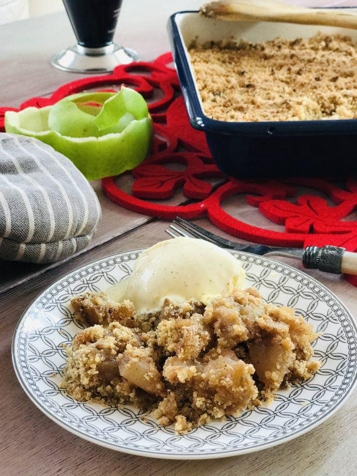 Plate with apple crumble and scoop of ice cream