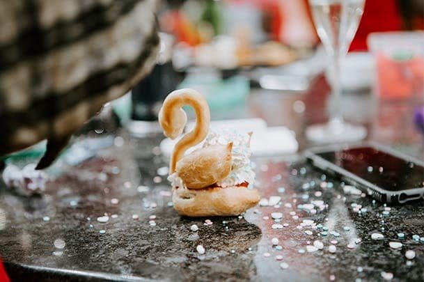 Choux pastry swan on marble counter