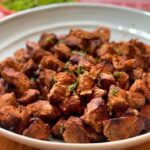 tandoori lamb in a large blue dish