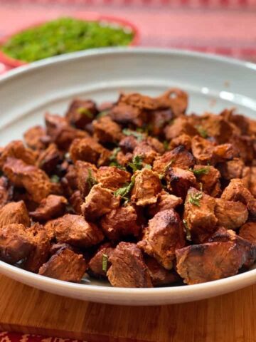 tandoori lamb in a large blue dish