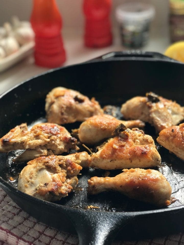 pieces of chicken spaced apart from one another in a large skillet