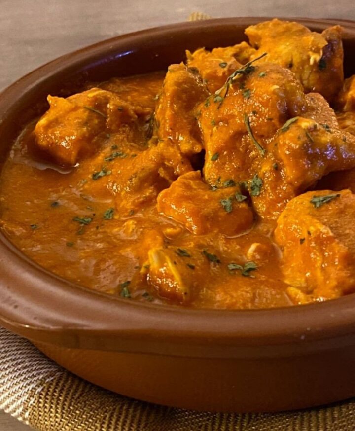 butter chicken in a brown bowl