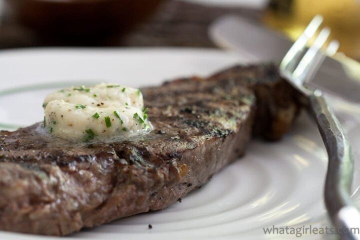 close up of steak with melting round of butter