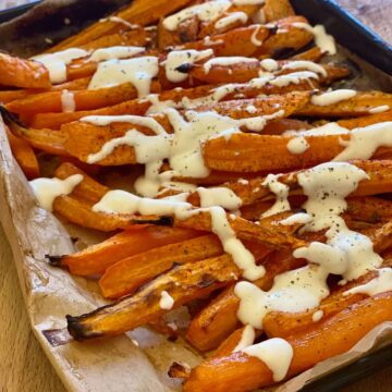 Roasted carrots with dressing on oven tray