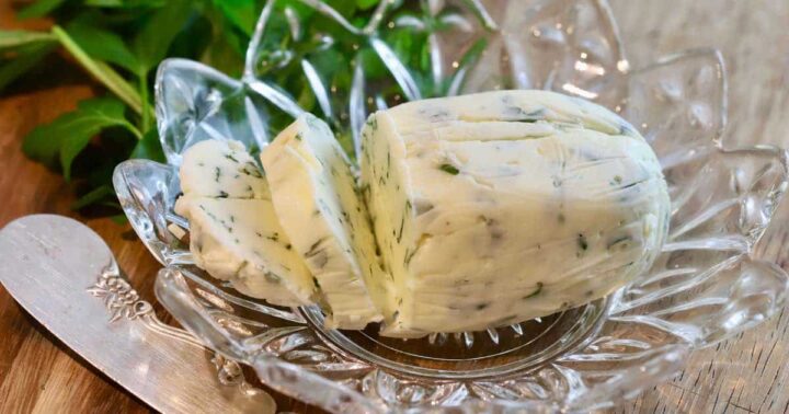 partially sliced butter log in glass dish