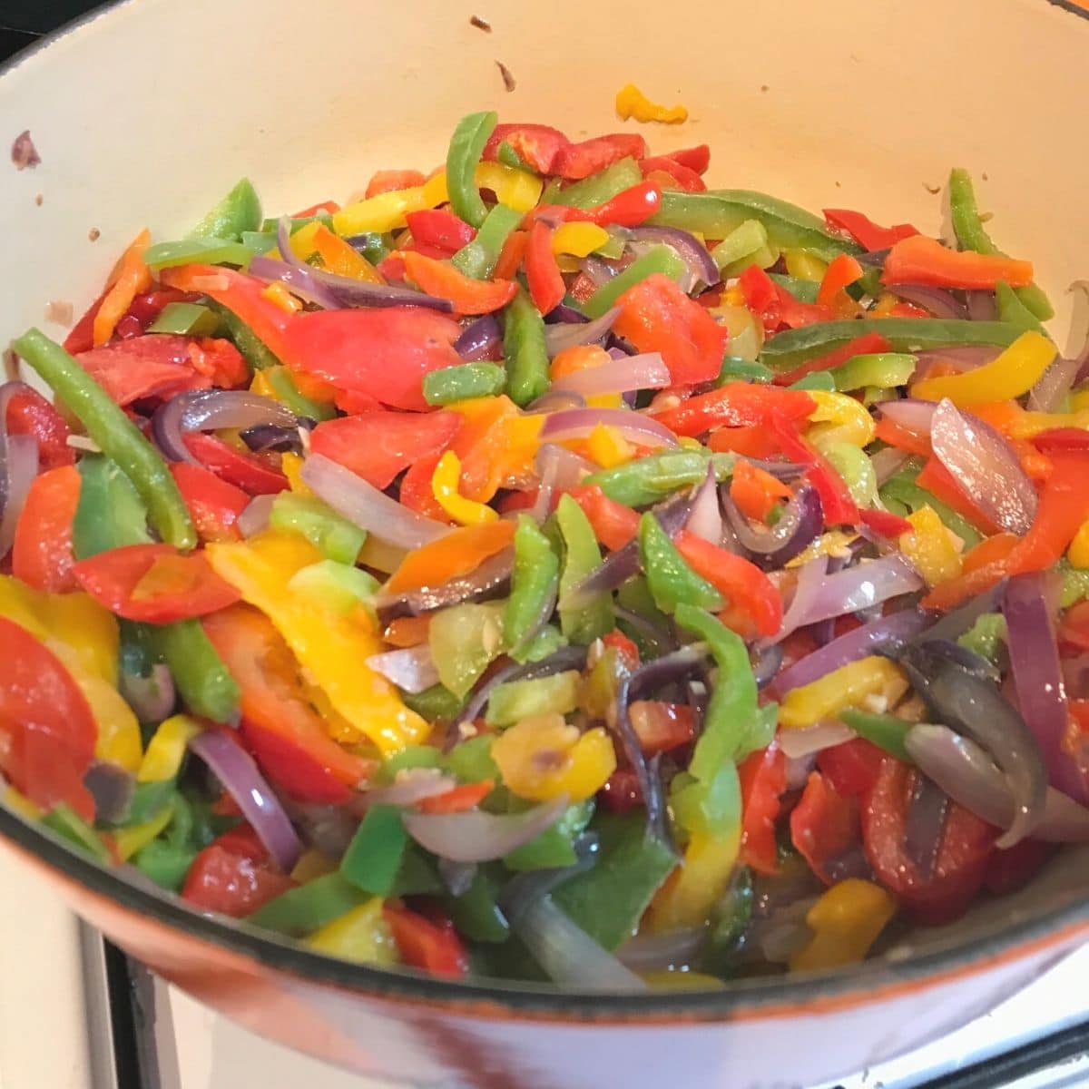 process shot of peppers in medium saucepan on stove