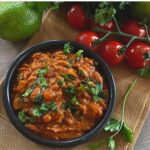 Pinto beans in small black bowl on table