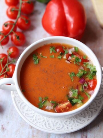 Gazpacho in white soup bowl with chopped vegetable garnish