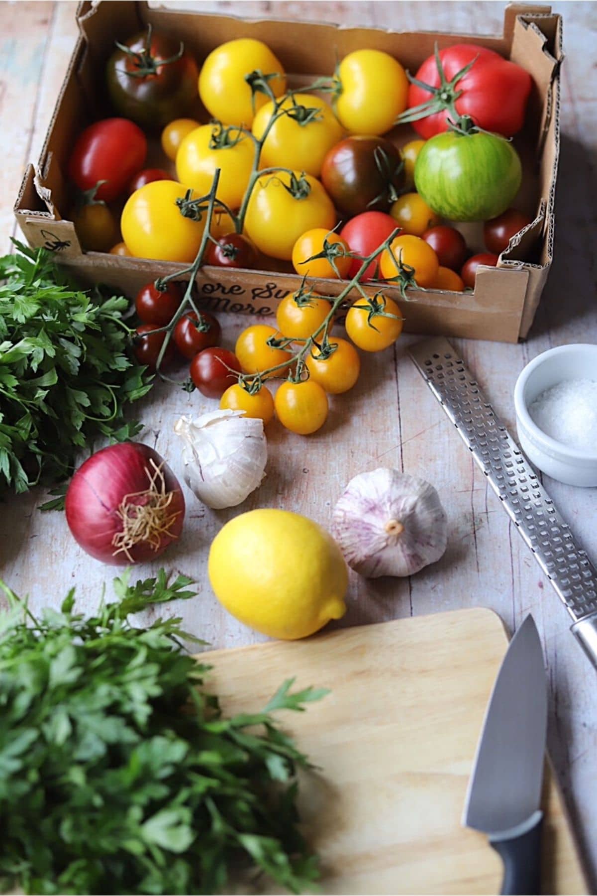 Ingredients for tomato salad on wooden table