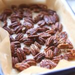 roasted pecans in a roasting dish