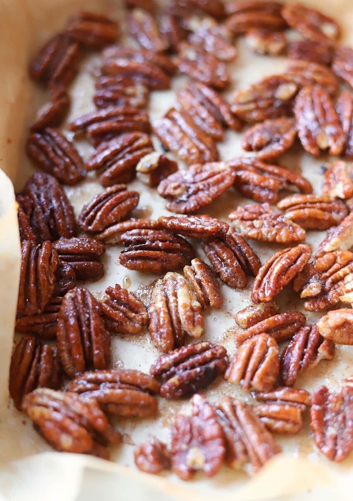 Honey roasted pecans on parchment paper 