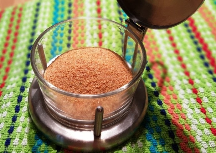 Image of orange seasoning in a glass container.