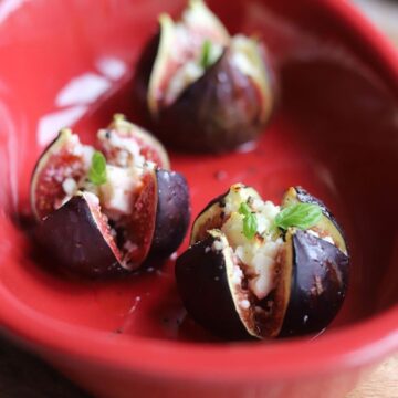 roasted stuffed figs in a red baking dish