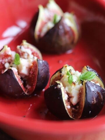 roasted stuffed figs in a red baking dish