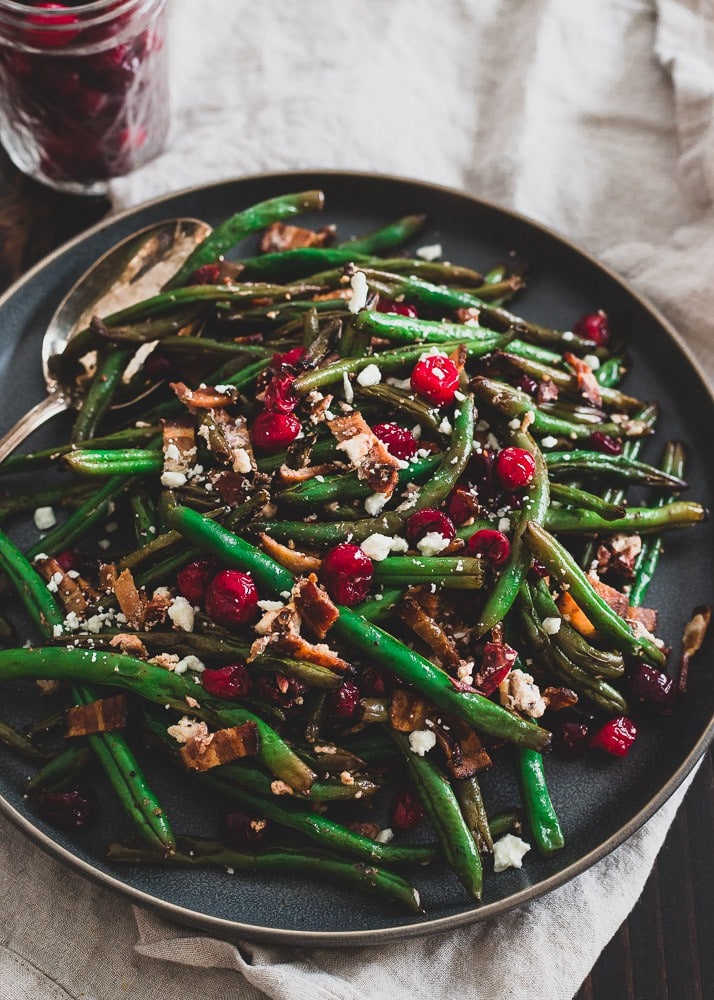 green beans with cranberries on large black serving dish