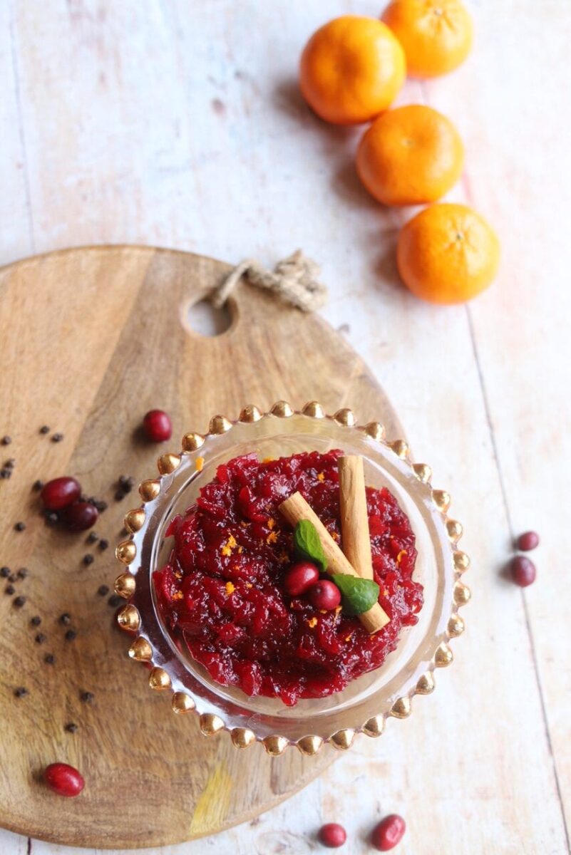 Pin image of cranberry sauce alongside oranges and spices