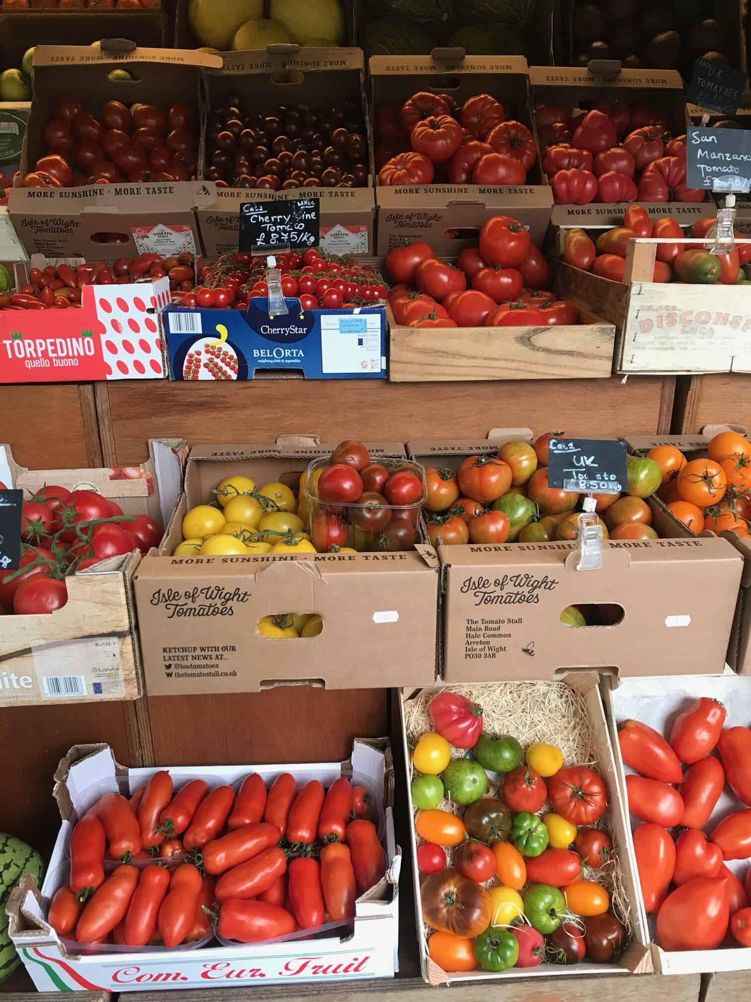 Different varieties fresh tomatoes in crates.