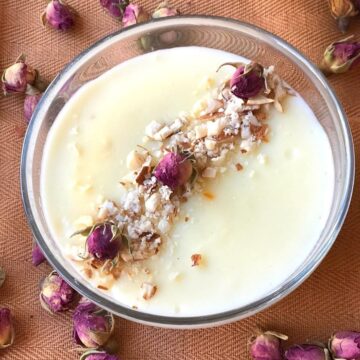 Firni in glass bowl with garnish of small dried roses