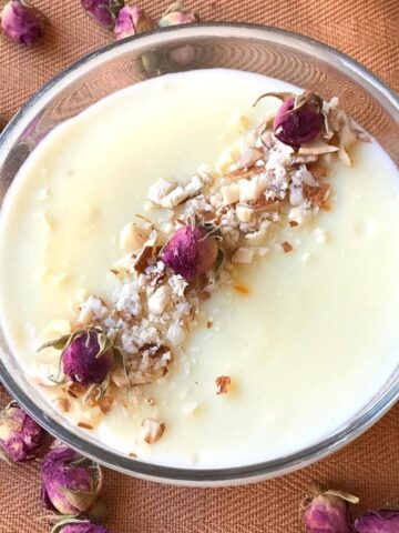 Firni in glass bowl with garnish of small dried roses