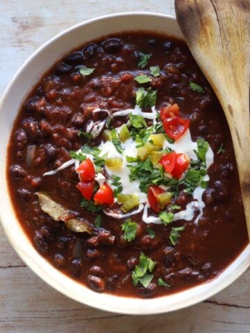 Black bean stew with sour cream, tomatoes herbs, jalapenos