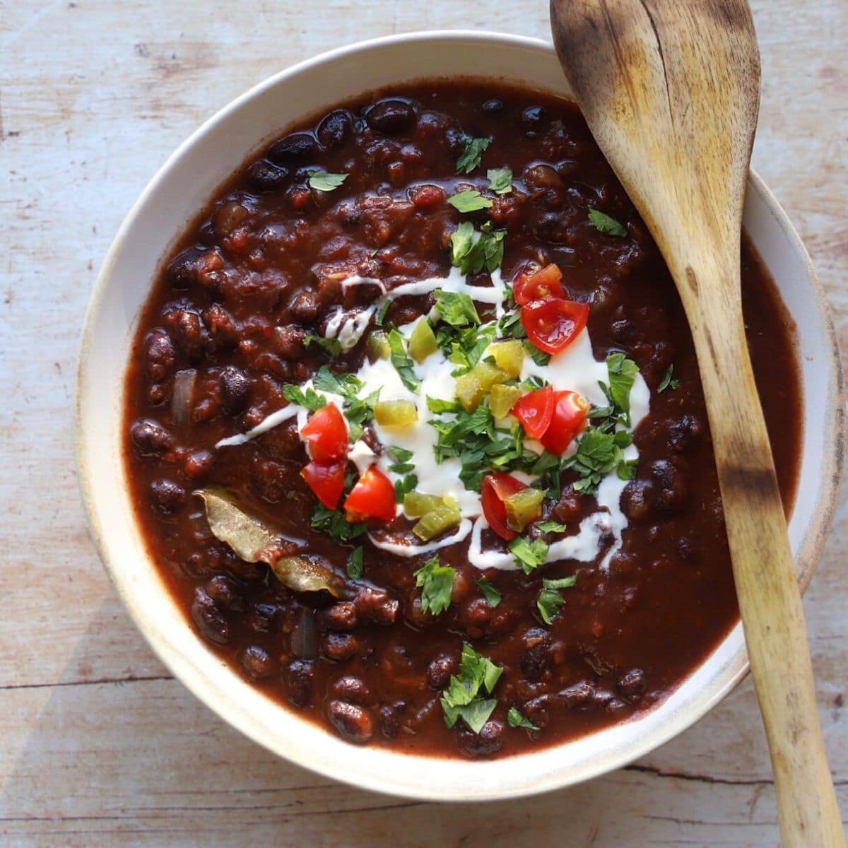 Black bean stew with sour cream, tomatoes herbs and  jalapenos.