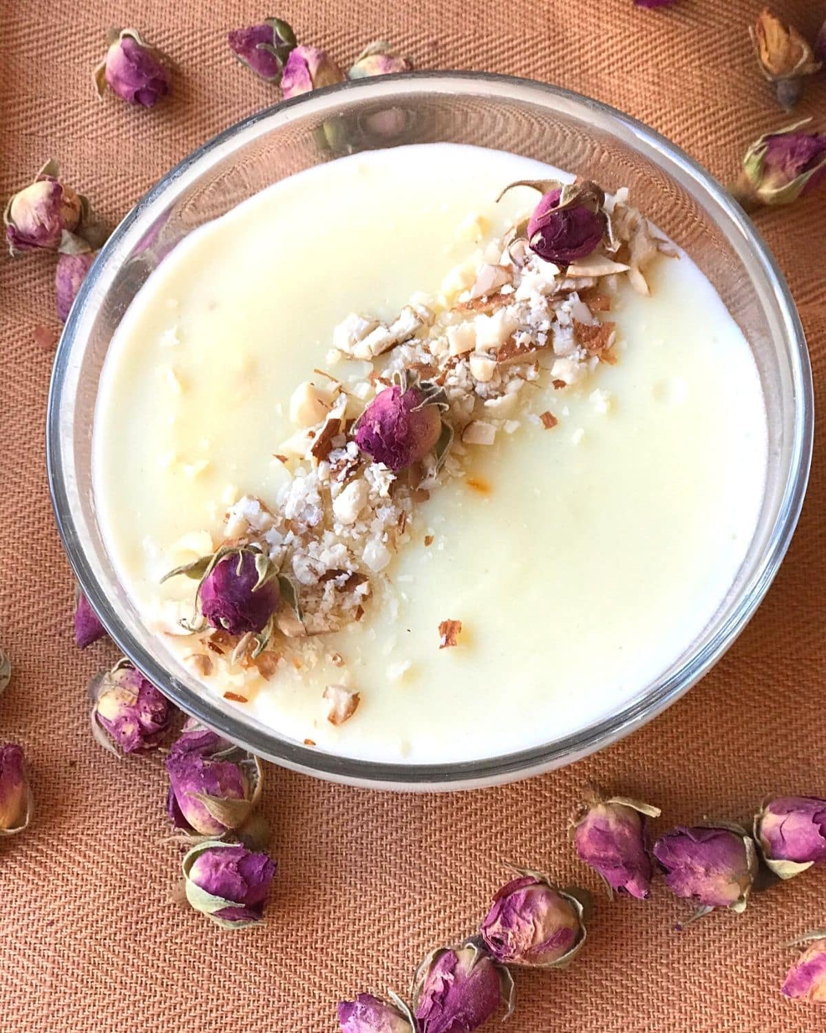 Firni in glass bowl garnished with small dried roses