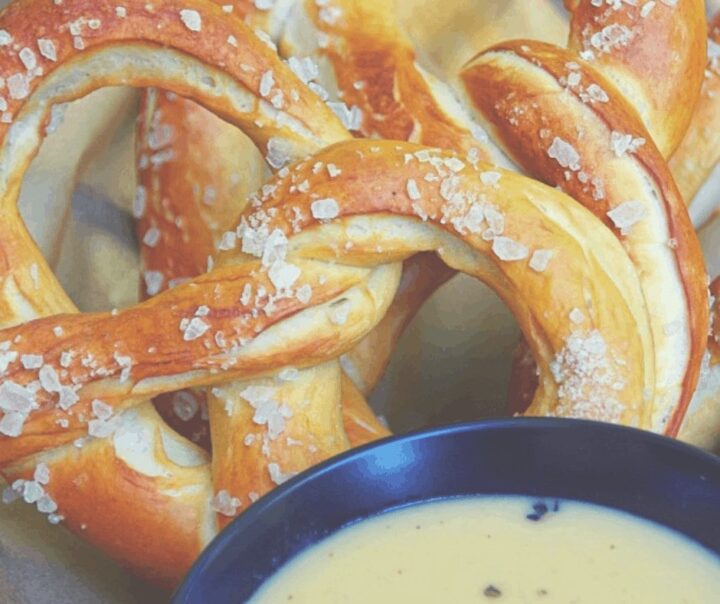 Image of pretzel closeup with cheese dip.
