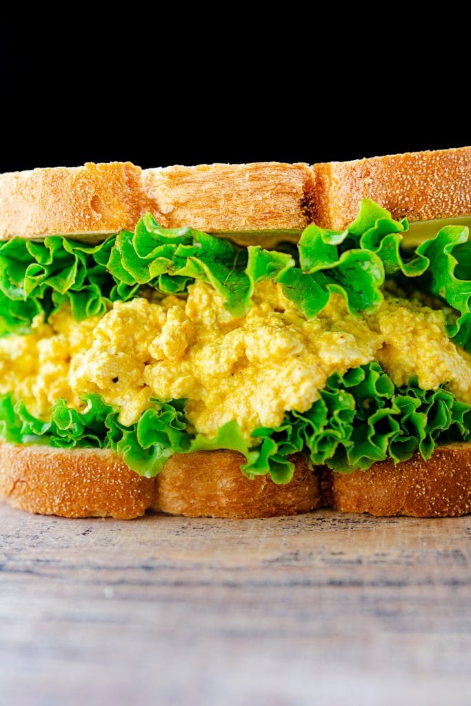 Image of closeup of vegan egg sandwich with lettuce.