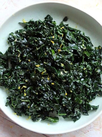Image closeup of cooked cavolo nero in green bowl.
