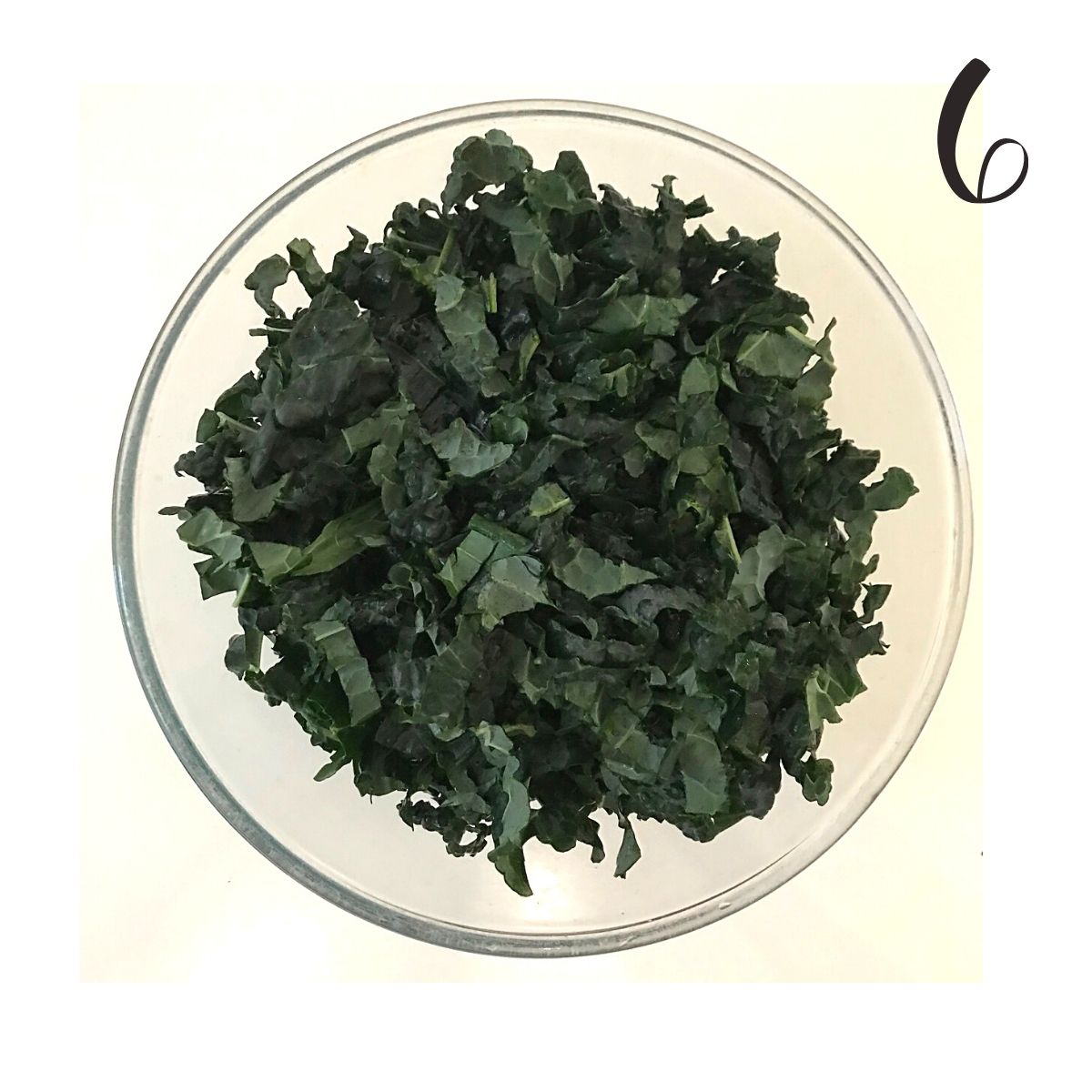 Step 6 showing chopped cavolo nero in a glass bowl.