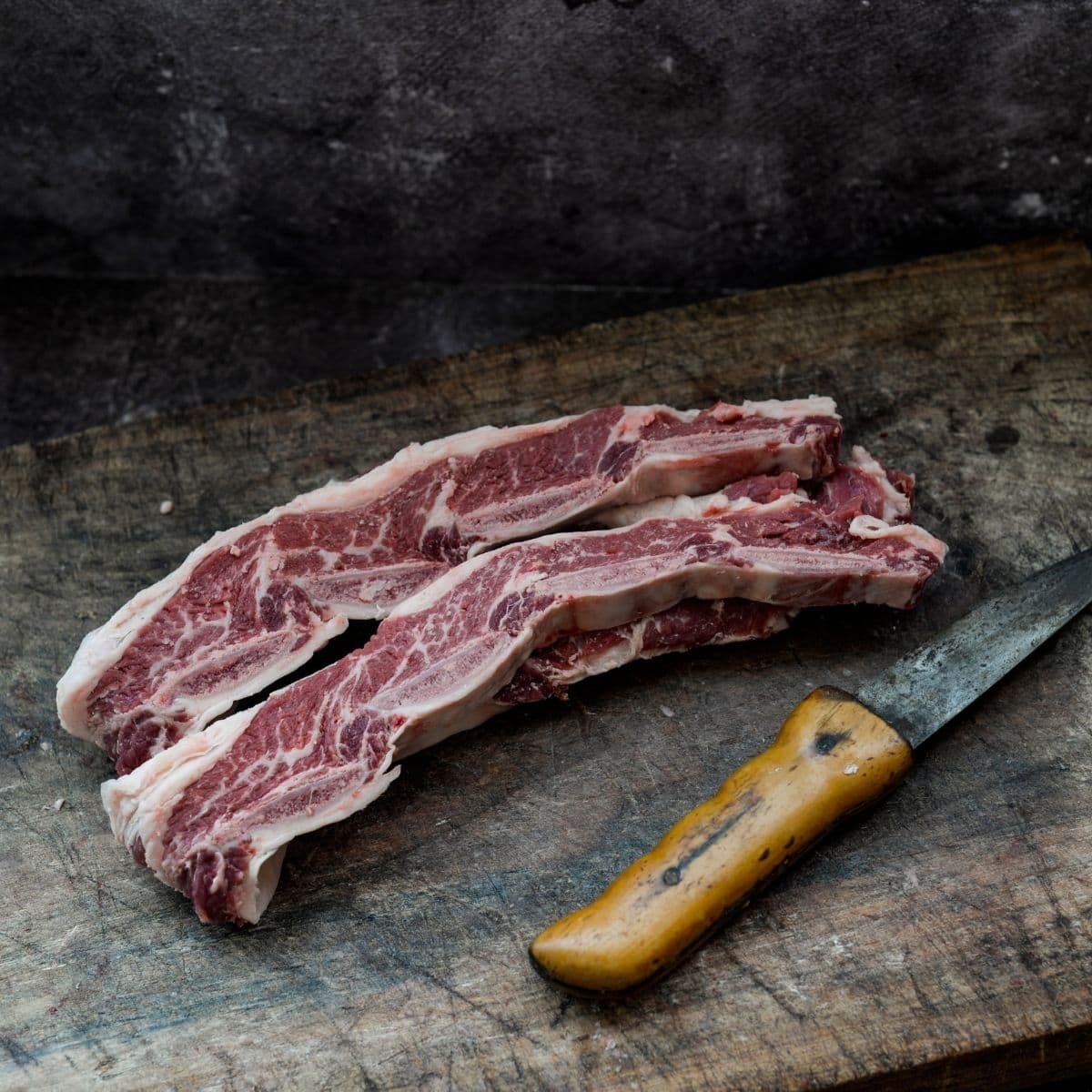 strips of meat next to a knife on chopping board