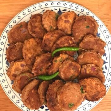 Image of plate of shami kebabs on round plate.