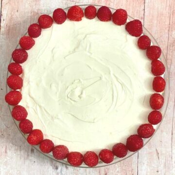 Image of lemon cheesecake decorated with raspberries.
