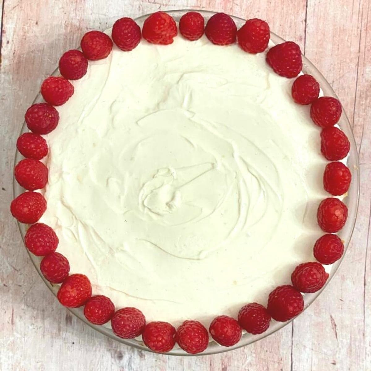 Lemon cheesecake decorated with raspberries