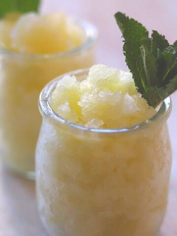 Two jars of granita with sprig of mint.