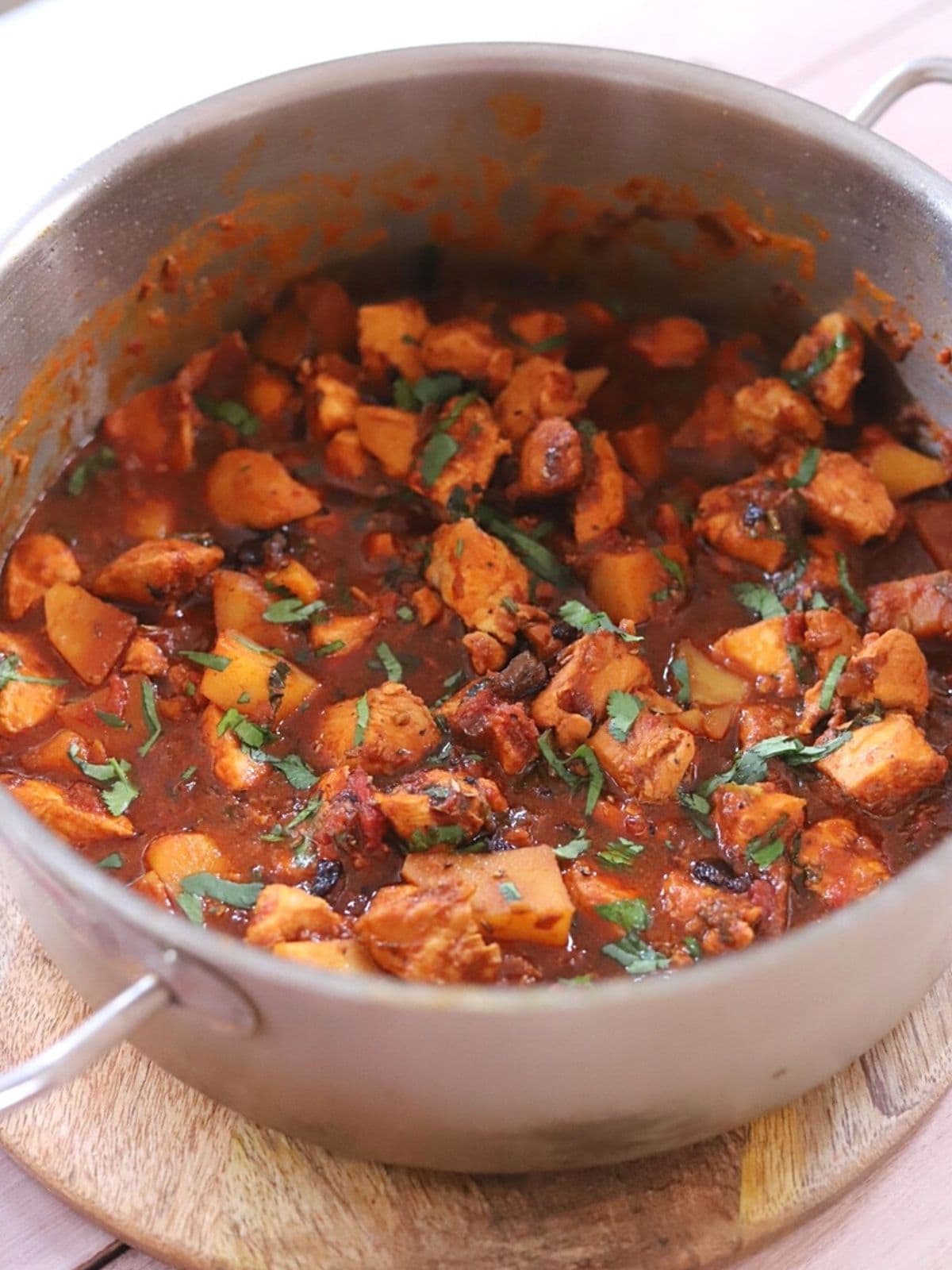 Chicken curry with potatoes in saucepan.