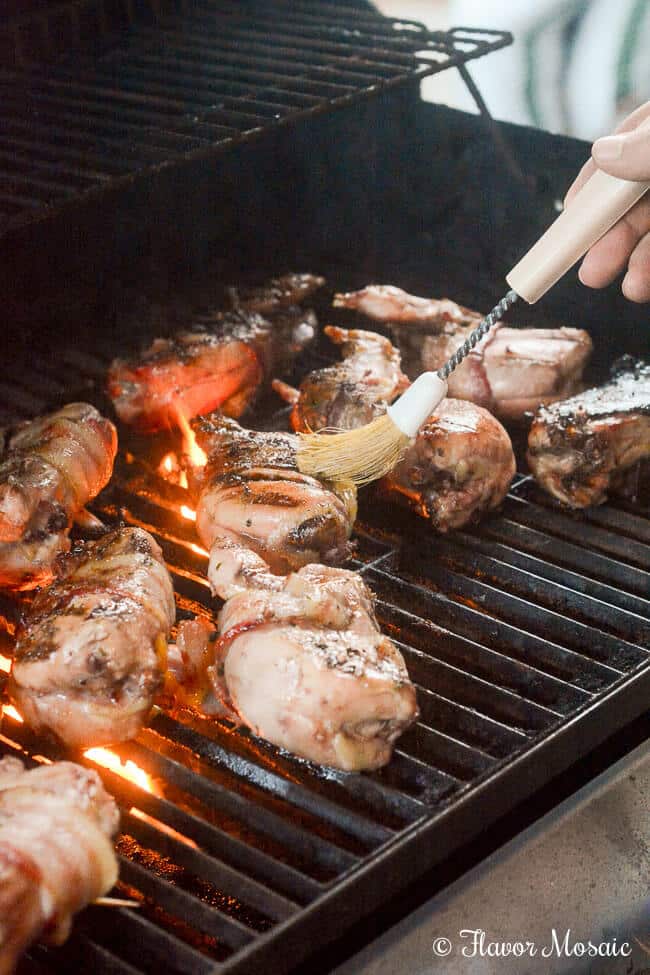 Image of basting quail on the grill.