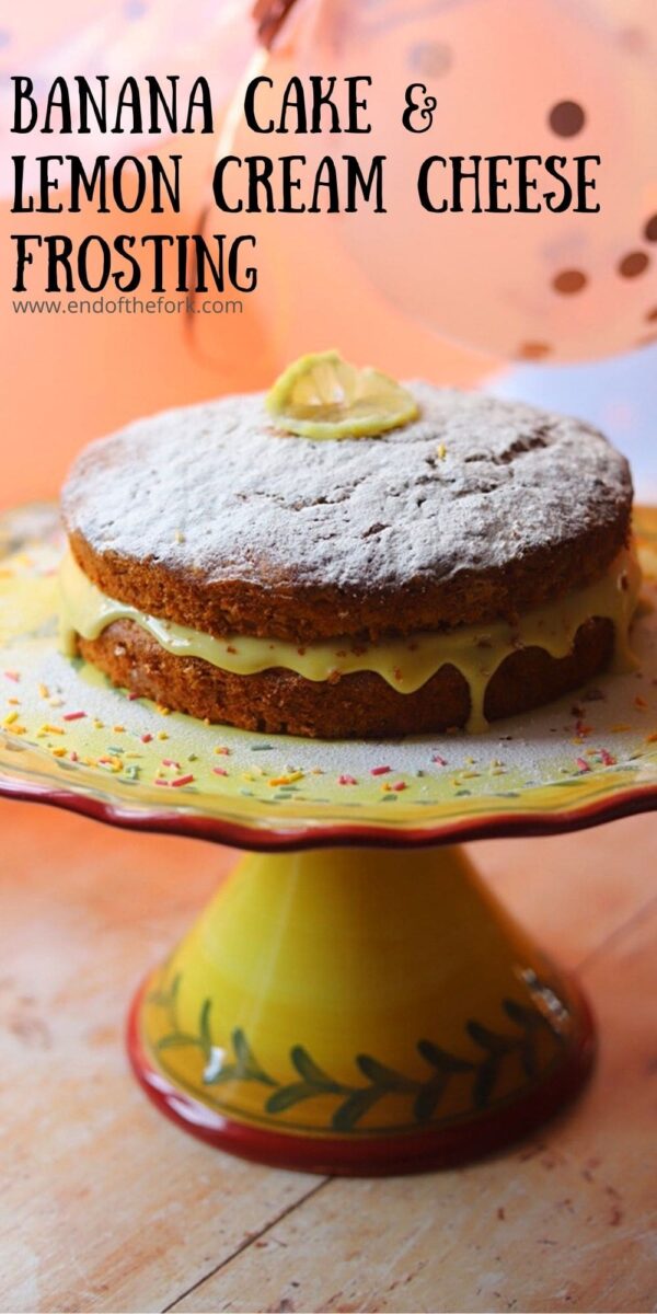 Pin image of banana cake with cream cheese frosting on a yellow cake stand.