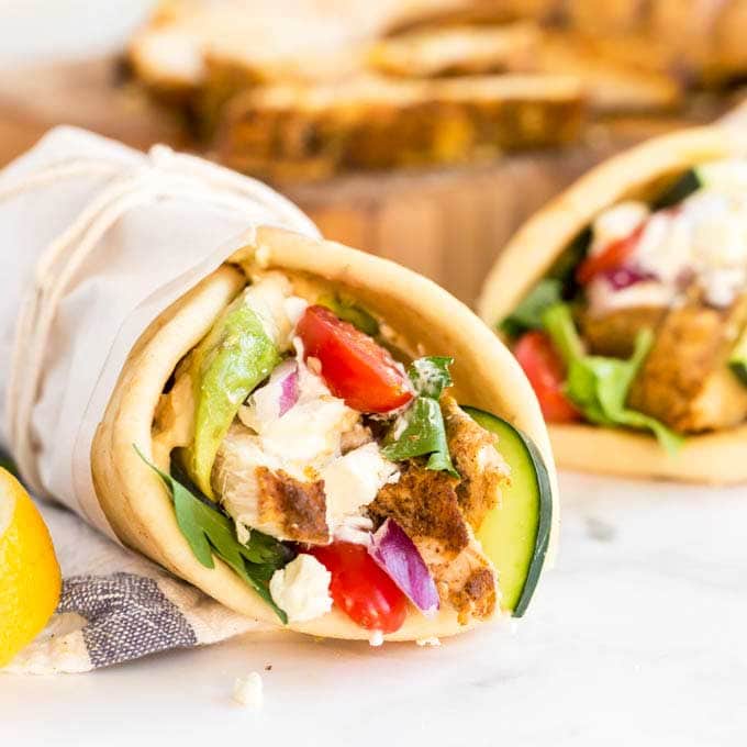 Image of two chicken and salad filled shawarma wraps.