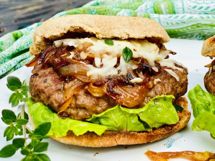Image of stuffed chicken and onion burger with cheese and lettuce.